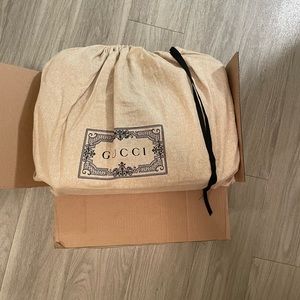 Tan and brown Gucci supreme diaper bag.